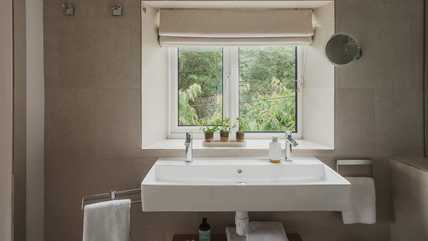 The ensuite is complete with a large rainfall shower, dual sink, heated towel rail and underfloor heating