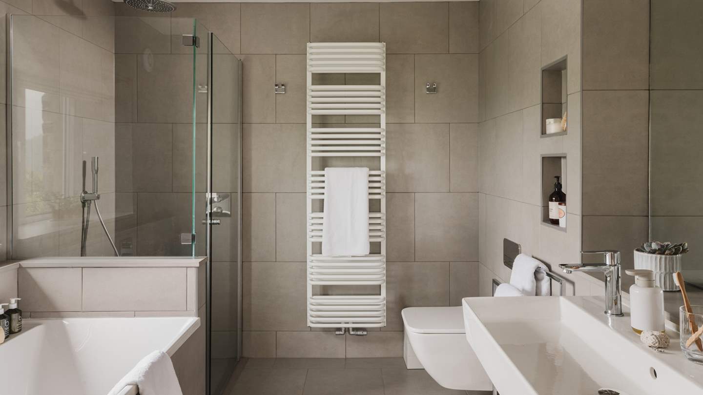 For refreshing morning showers and bubble-topped soaks, uncover the ensuite bathroom 