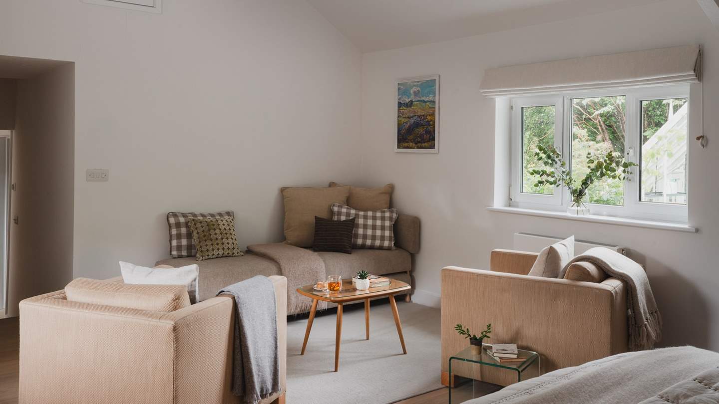 At the far side of this space, you’ll find two armchairs and a Smart TV