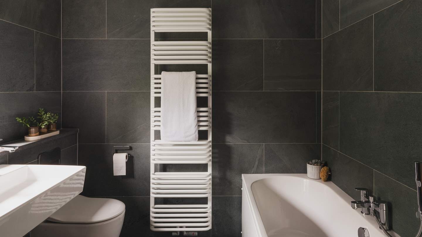 The ensuite is tiled in shades of the locally mined Honister slate 