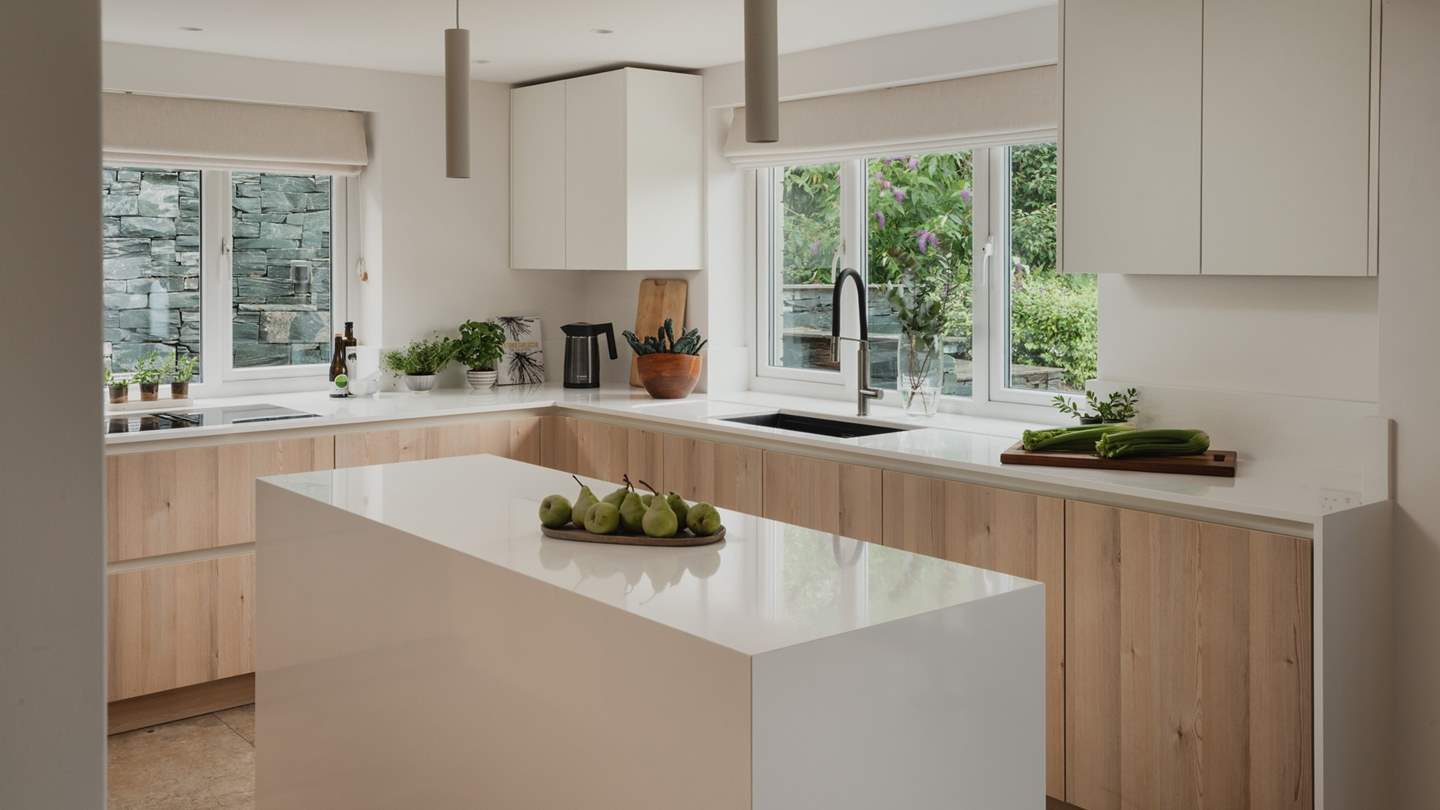 The kitchen blends Scandi minimalism with mid-century modern charm