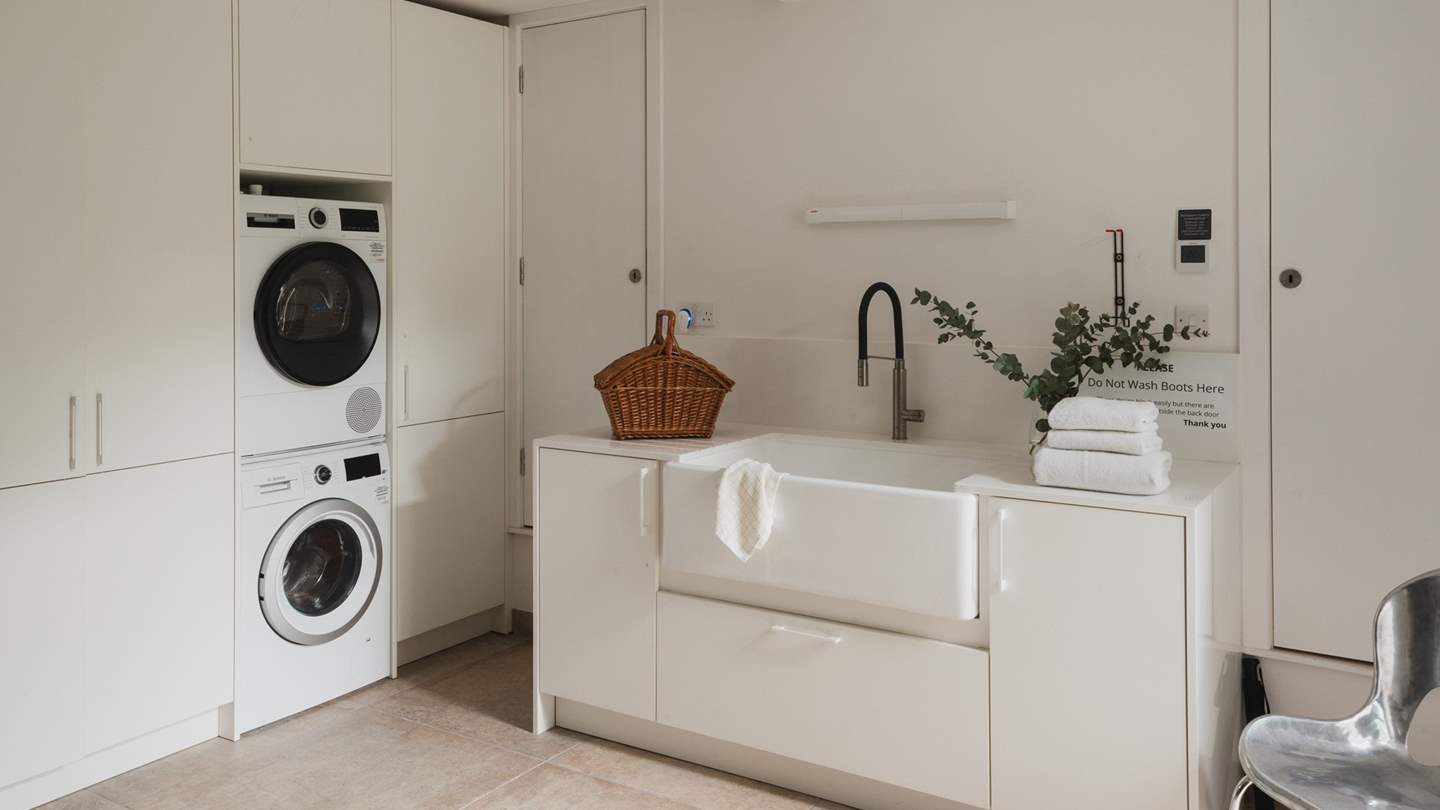 The large well-equipped boot room offers direct access outside, complete with underfloor heating 