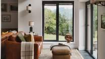 A calming space to soak up the magnificent views, you’ll find an additional seating by the bi-fold doors 