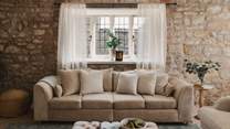 The living and dining room is beautifully adorned with soft, neutral tones 