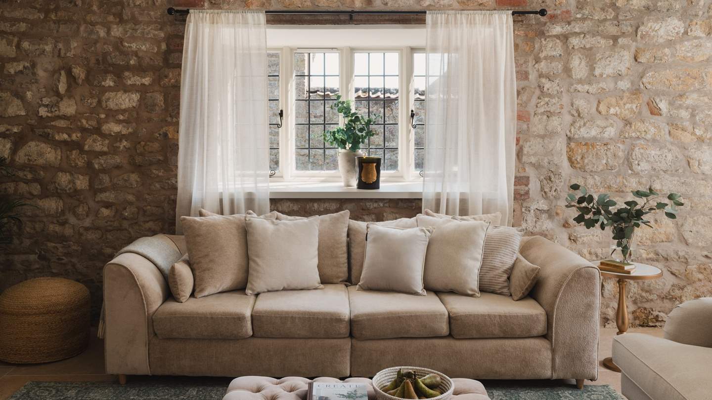 The living and dining room is beautifully adorned with soft, neutral tones 