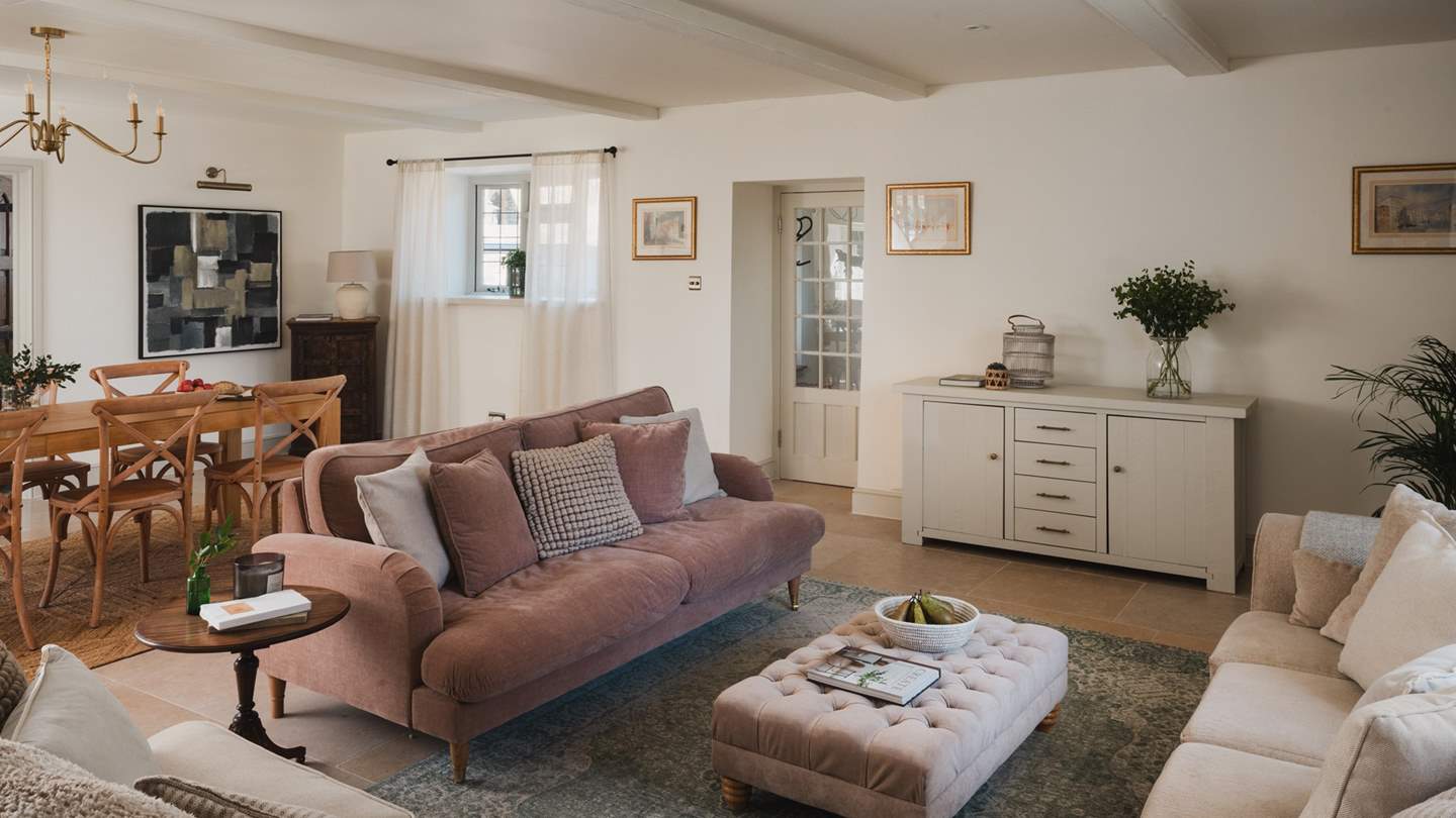 Unwind in style on a choice of three cosy sofas, each gathered around a linen ottoman coffee table