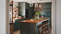Boasting a bespoke shaker kitchen in soothing emerald hues with brass accents, the kitchen is a sumptuous space for crafting feasts 