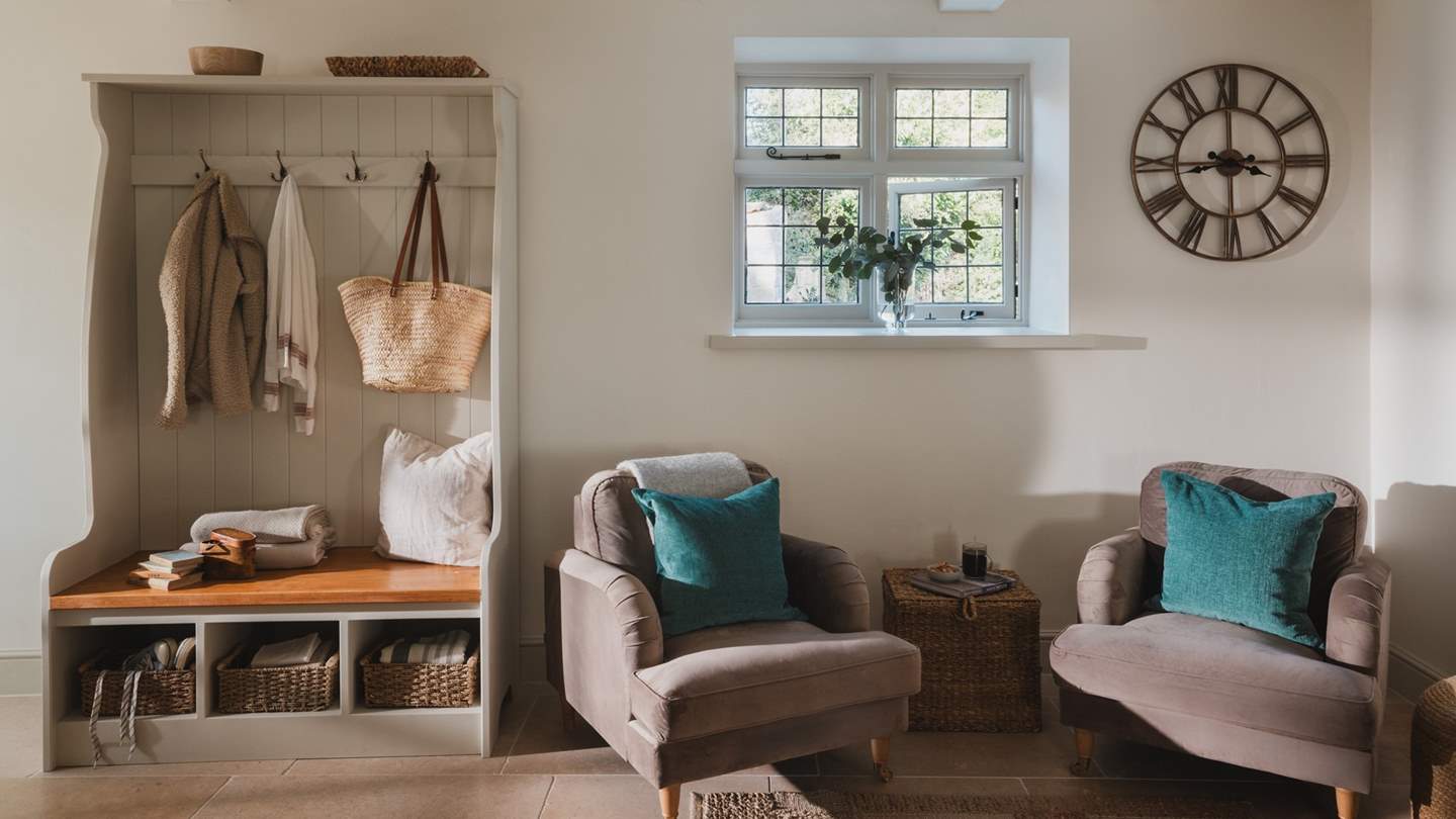 Two armchairs promise a snug spot to settle and admire the culinary artist of your party 