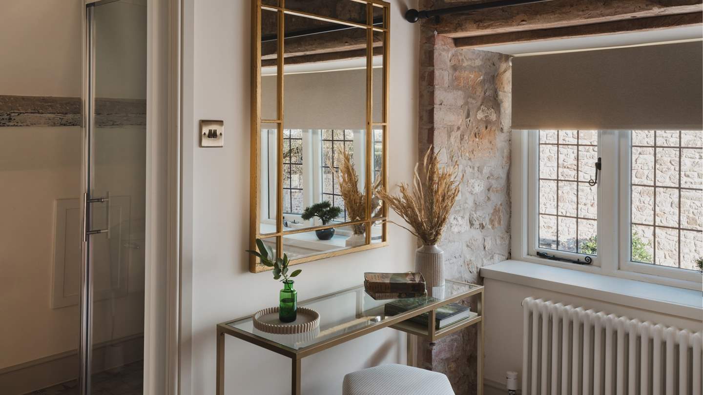 A contemporary dressing table is complete with a stool 