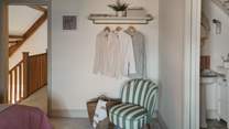 You'll also find a striped occasional chair and small hanging rail