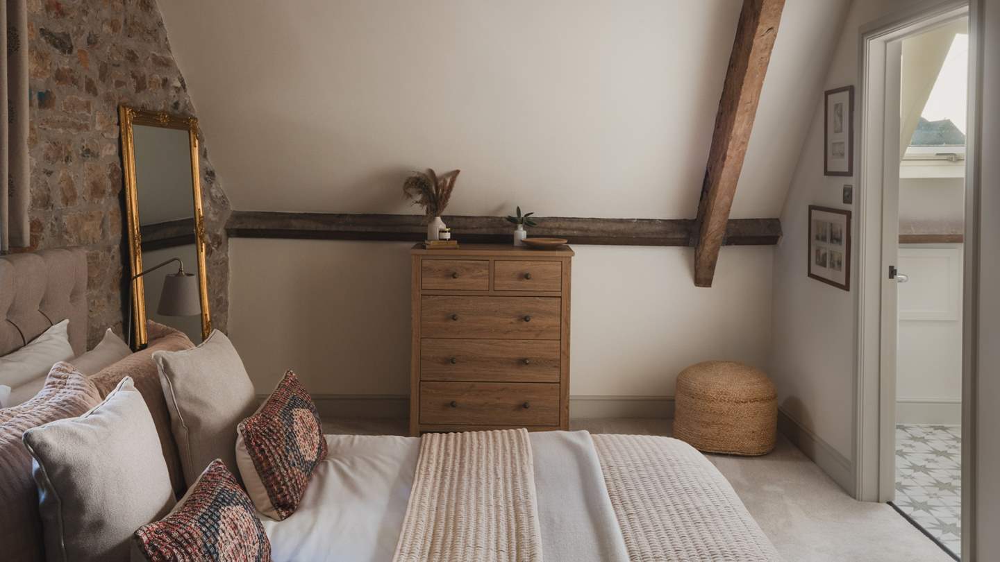 For stowing belongings, you’ll find a pine chest of drawers and a hanging rail