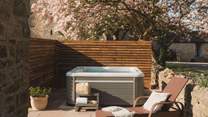 Set beneath tangled magnolia tree canopies is a hidden, electric hot tub