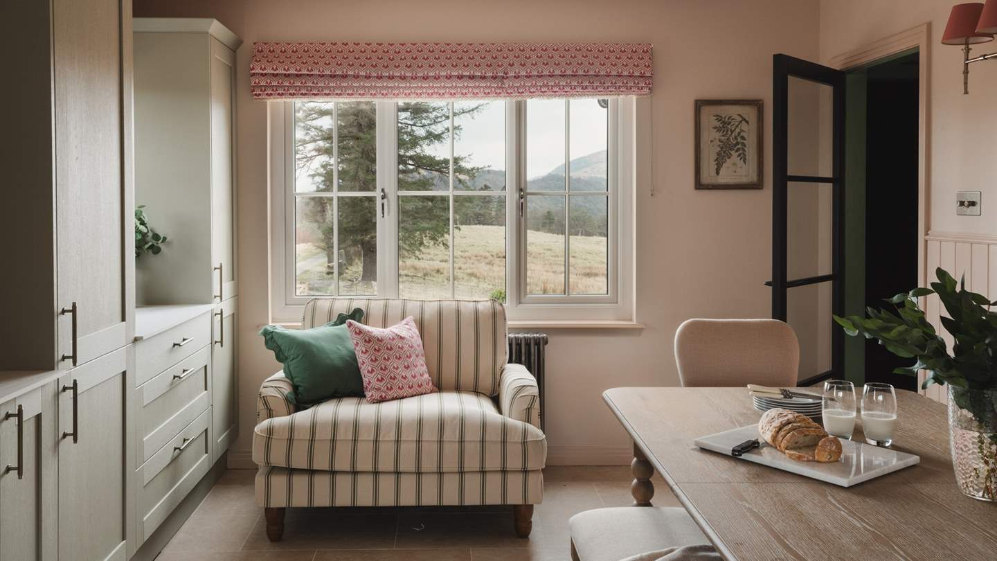 Relax with your morning coffee on the comfortable striped loveseat, a calming space to savour slow mornings 