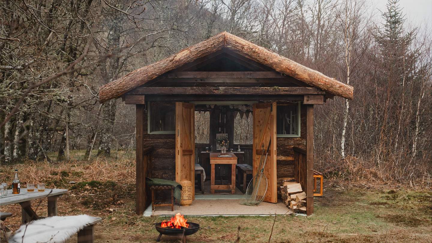 An alpine chalet cabin rests amidst enchanting woodland alongside the estate’s beautiful private river 