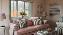 Sink into deep, plush sofas in soothing shades of pink and sage