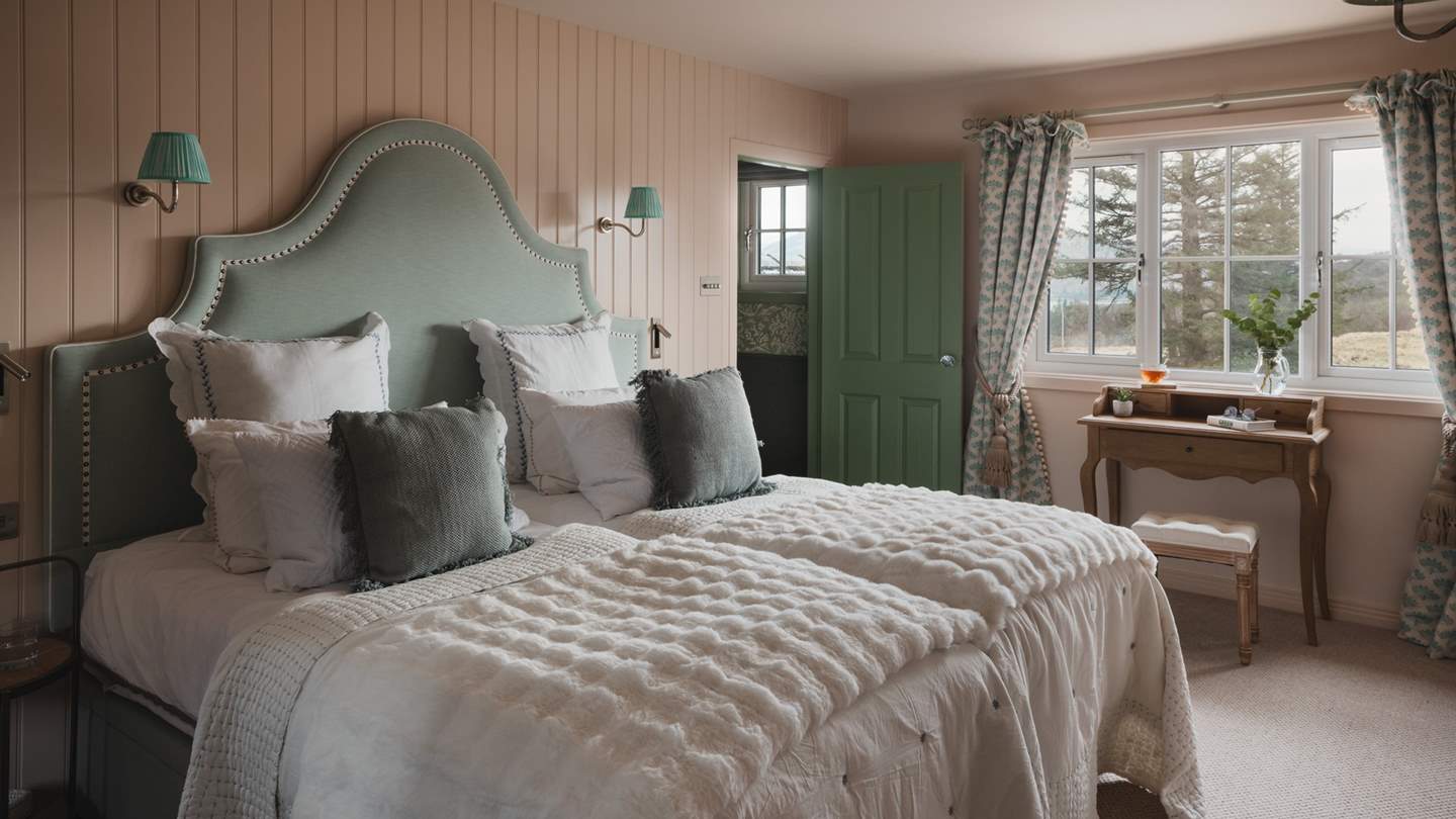 The first bedroom, colour drenched in calming plaster pink hues with panelling, invites for blissful repose amidst cloud-soft linens
