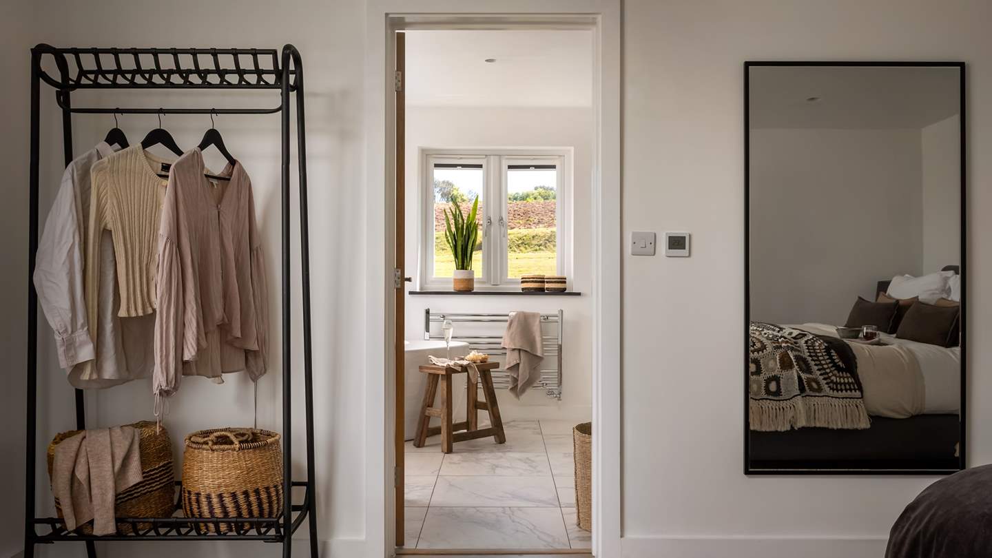 For storing your belongings, there are two bedside tables and a hanging rail