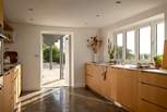Earthy tones and natural materials reign in the light-filled kitchen
