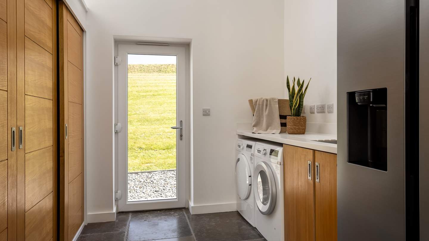 A spacious utility hosts a American-style fridge/freezer with an ice dispenser