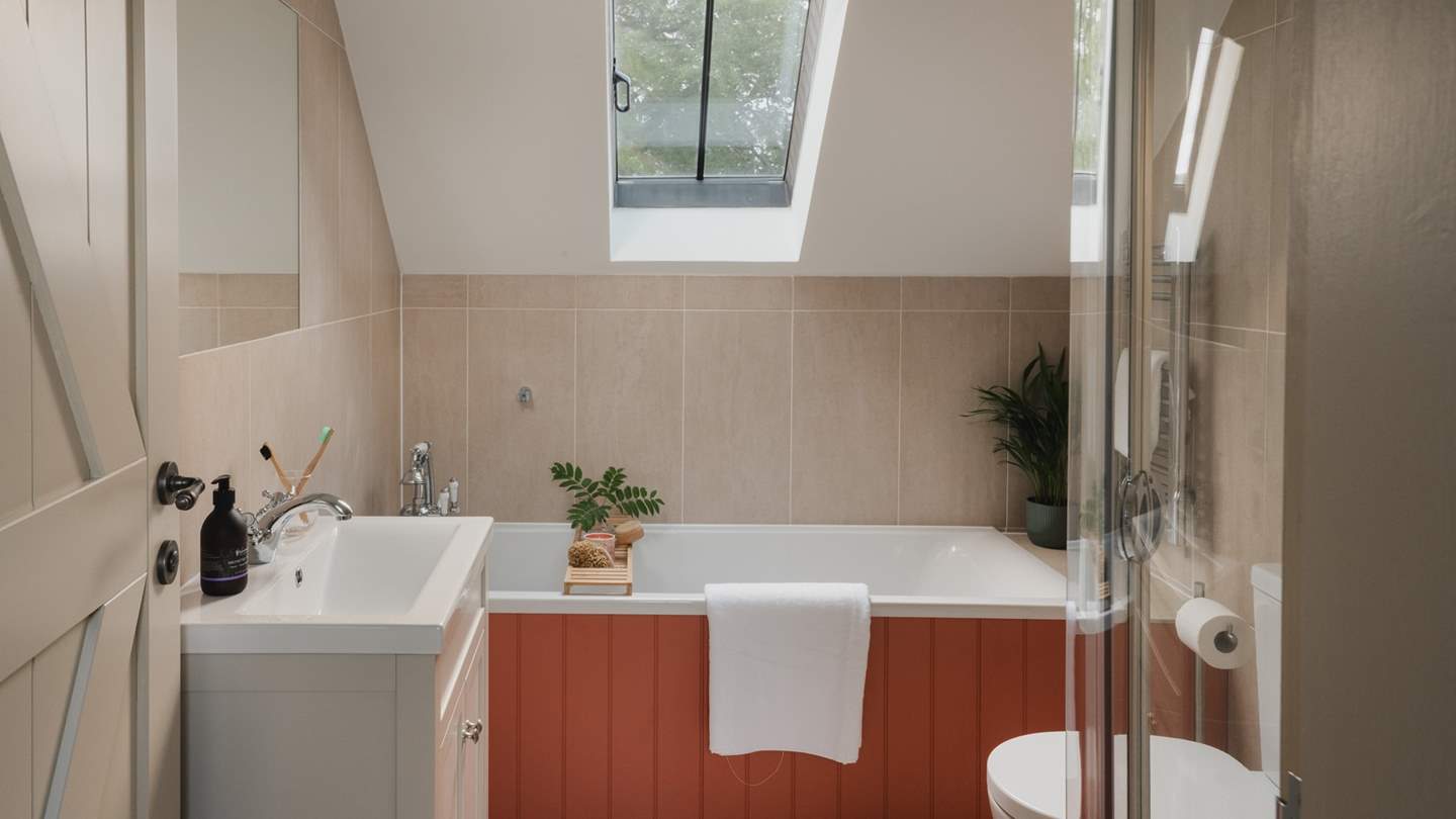 Enjoy soothing bubble-topped scenes with views of trees dancing above the rooftop in the family bathroom