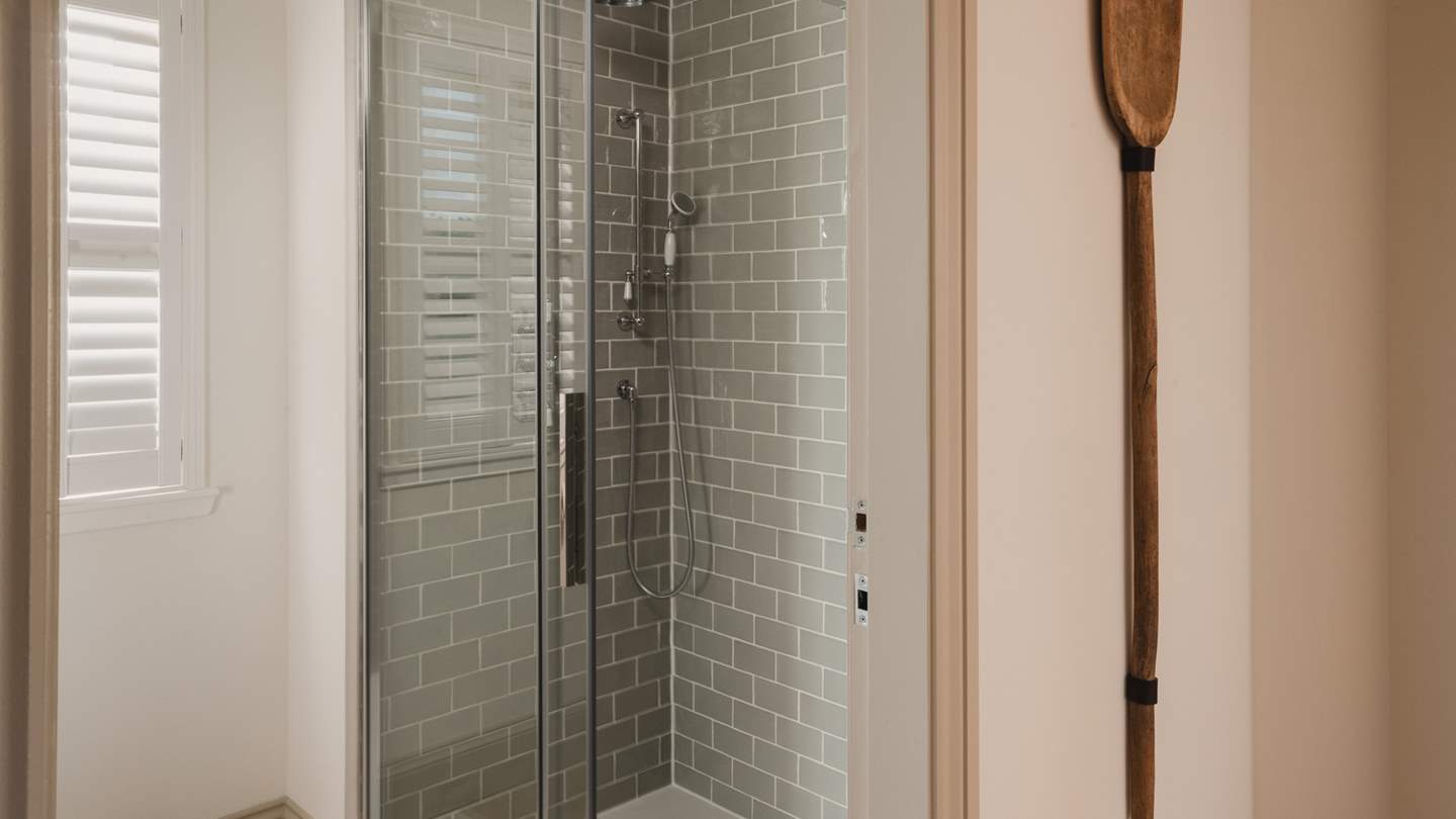 The ground floor shower room is tiled in shades of sage