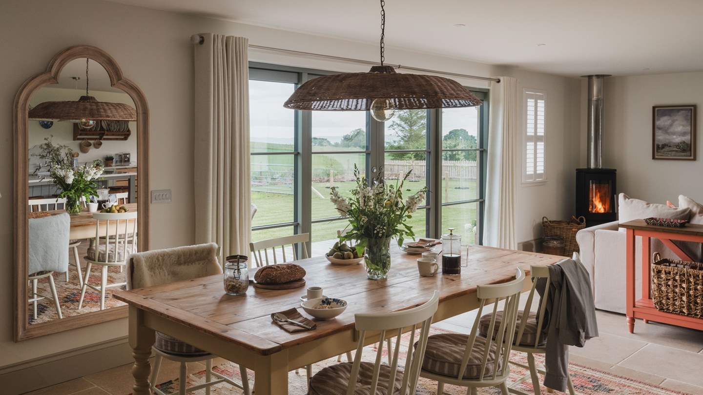 A modern wood burning stove is cleverly positioned in the corner of the room to create a welcoming atmosphere in the cooler months