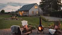 Retreat to the firepit area for cosy moments beside the chimenea