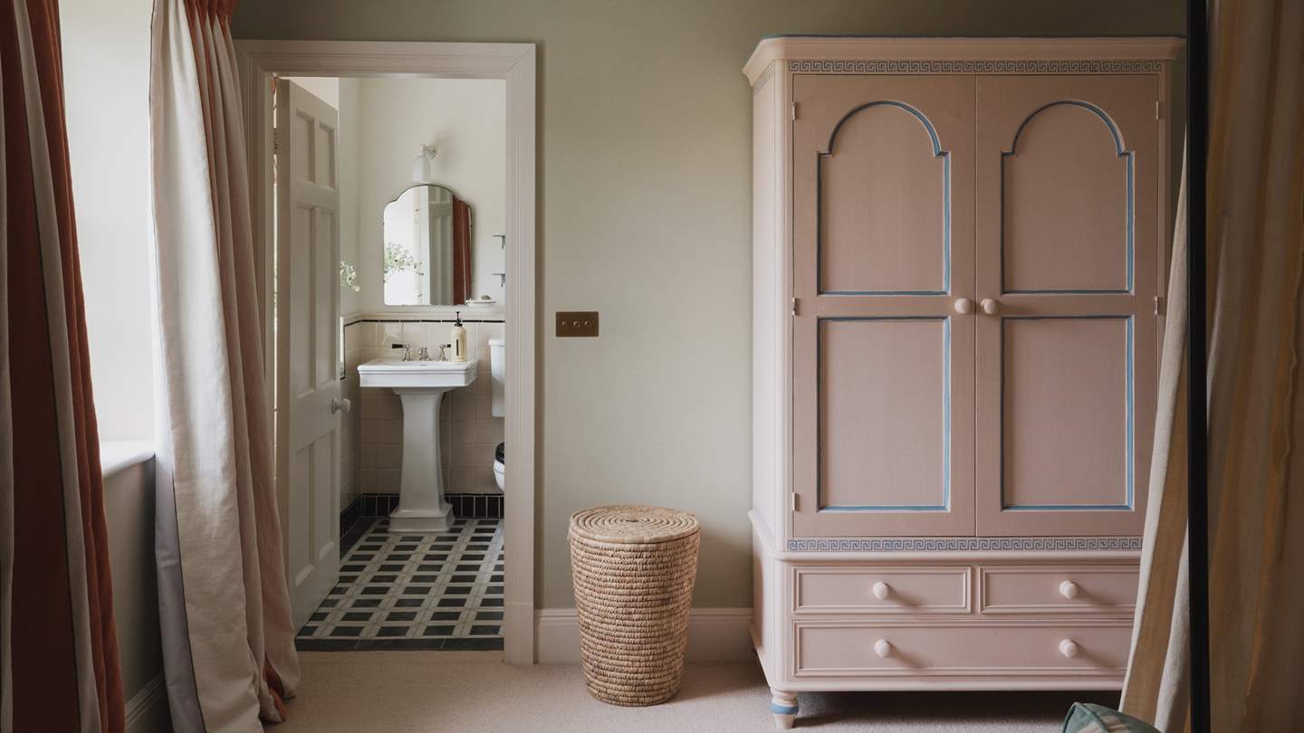 There is plenty of space for storing belongings, including a charming hand-painted pine wardrobe