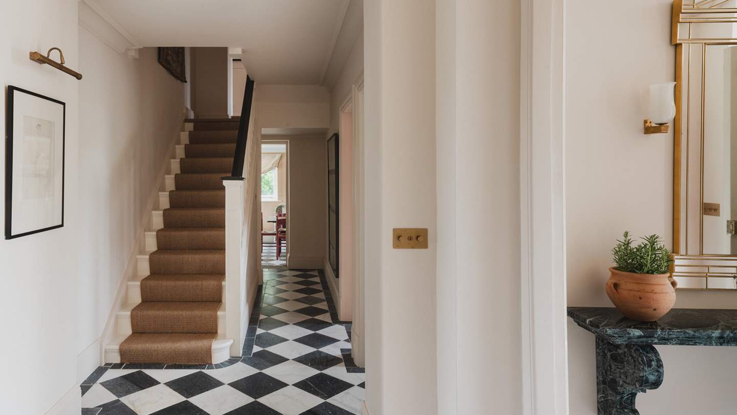 A Parisian chequer marbled hallway leads to an array of glamorous spaces