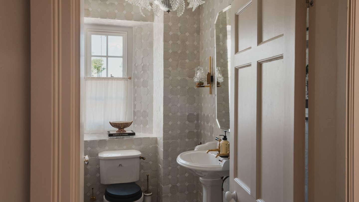 Downstairs near the hallway entrance awaits the glamorous Zelligge-clad powder room