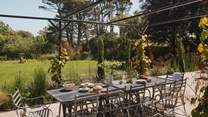 Afternoon aperitifs beneath the vine-wrapped pergola are a dream in the summer months