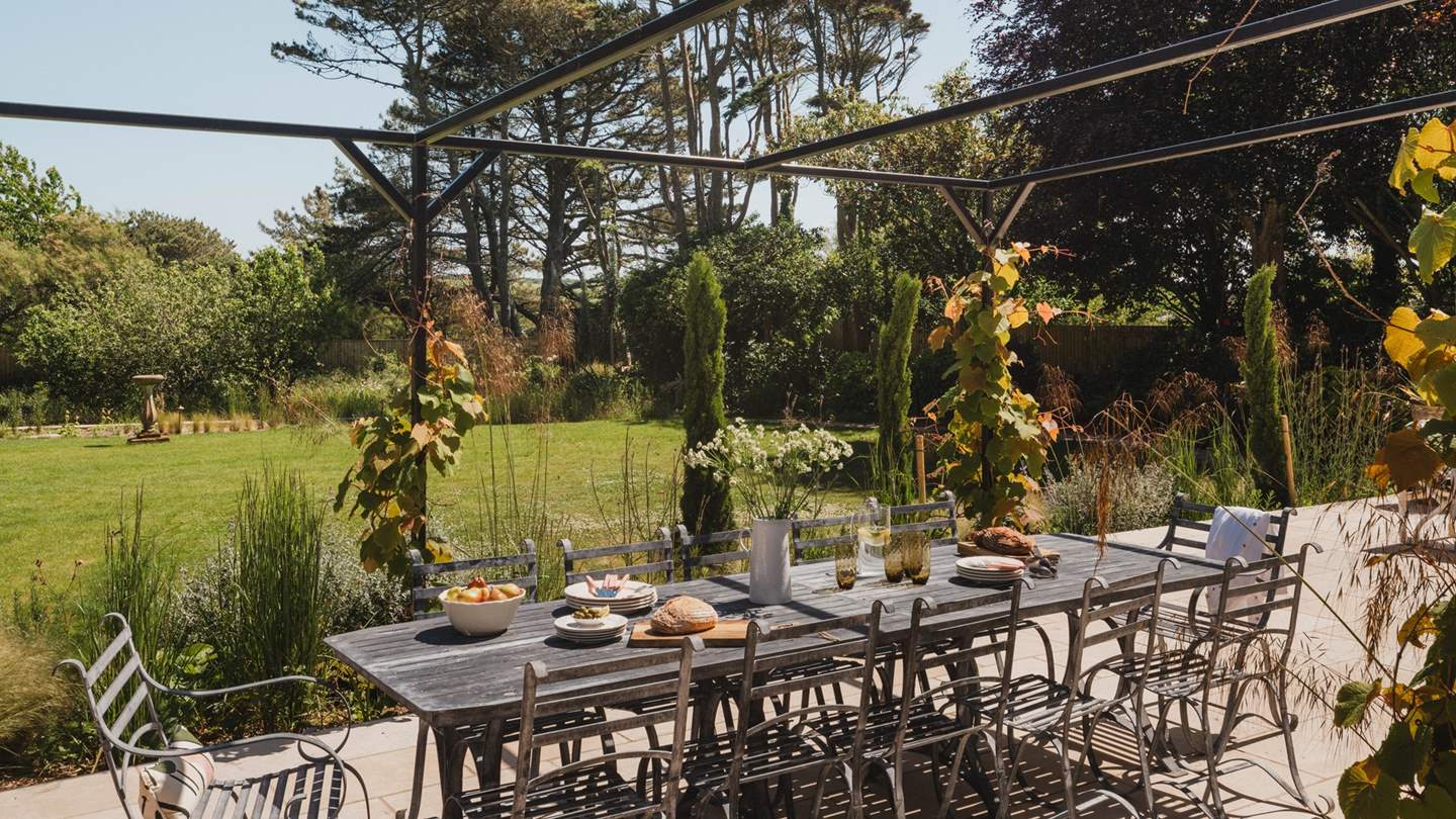 Afternoon aperitifs beneath the vine-wrapped pergola are a dream in the summer months