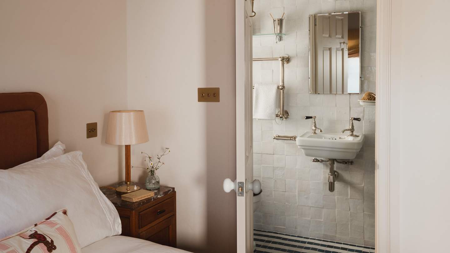 This bedroom's en suite is adorned with Moroccan Zelligge tiles