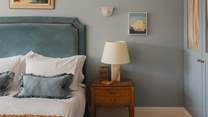 We adore the pretty antique bedside tables in this soothing setting
