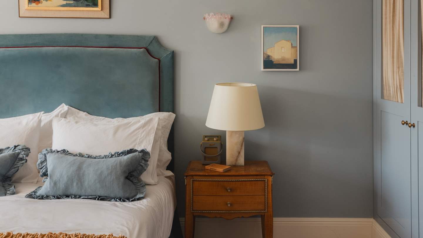 We adore the pretty antique bedside tables in this soothing setting