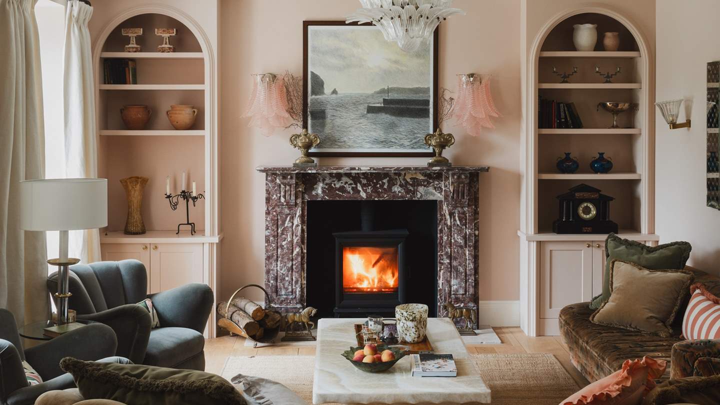 Drawing the eye in the living room is the remarkable antique marble fireplace