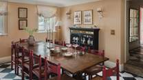 Gathered by mid-century chairs is the oak dining table for twelve - an enchanting spot to dine with music from the record player