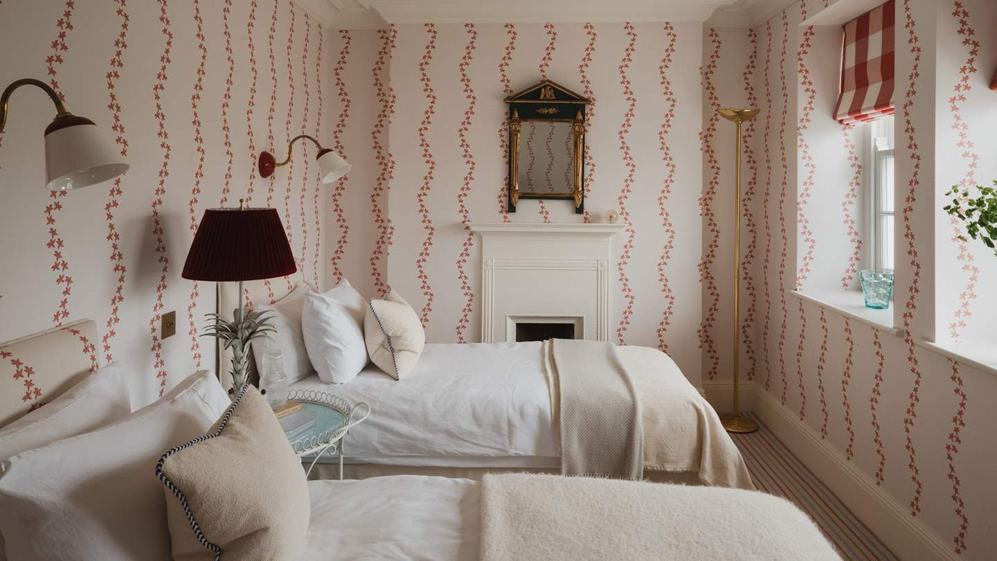 Adorned with sweet Ottoline Devries wallpaper and Beata Heuman wall lights, the final twin bedroom is a cosy space to reside