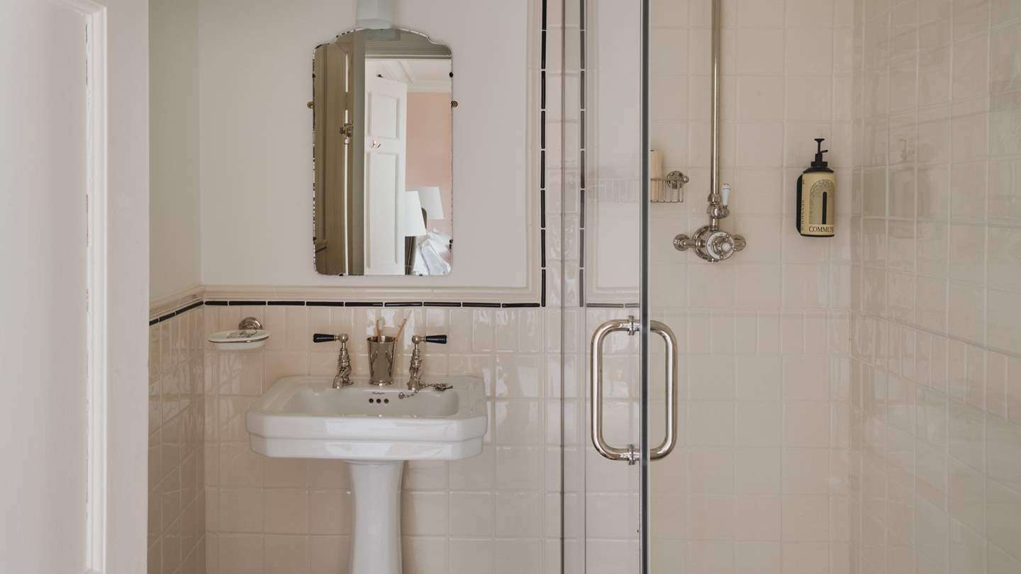 The darling en suite is adorned with bespoke Victorian-inspired tiles and complete with a Lefroy Brooks shower 