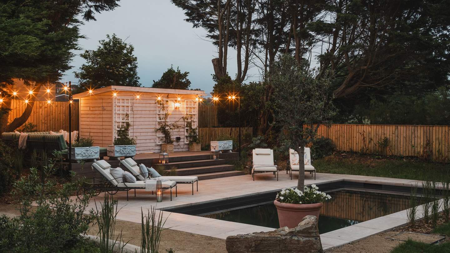 Adjacent is a separate sun-soaked seating area, an enchanting spot for summer cocktails until sunset