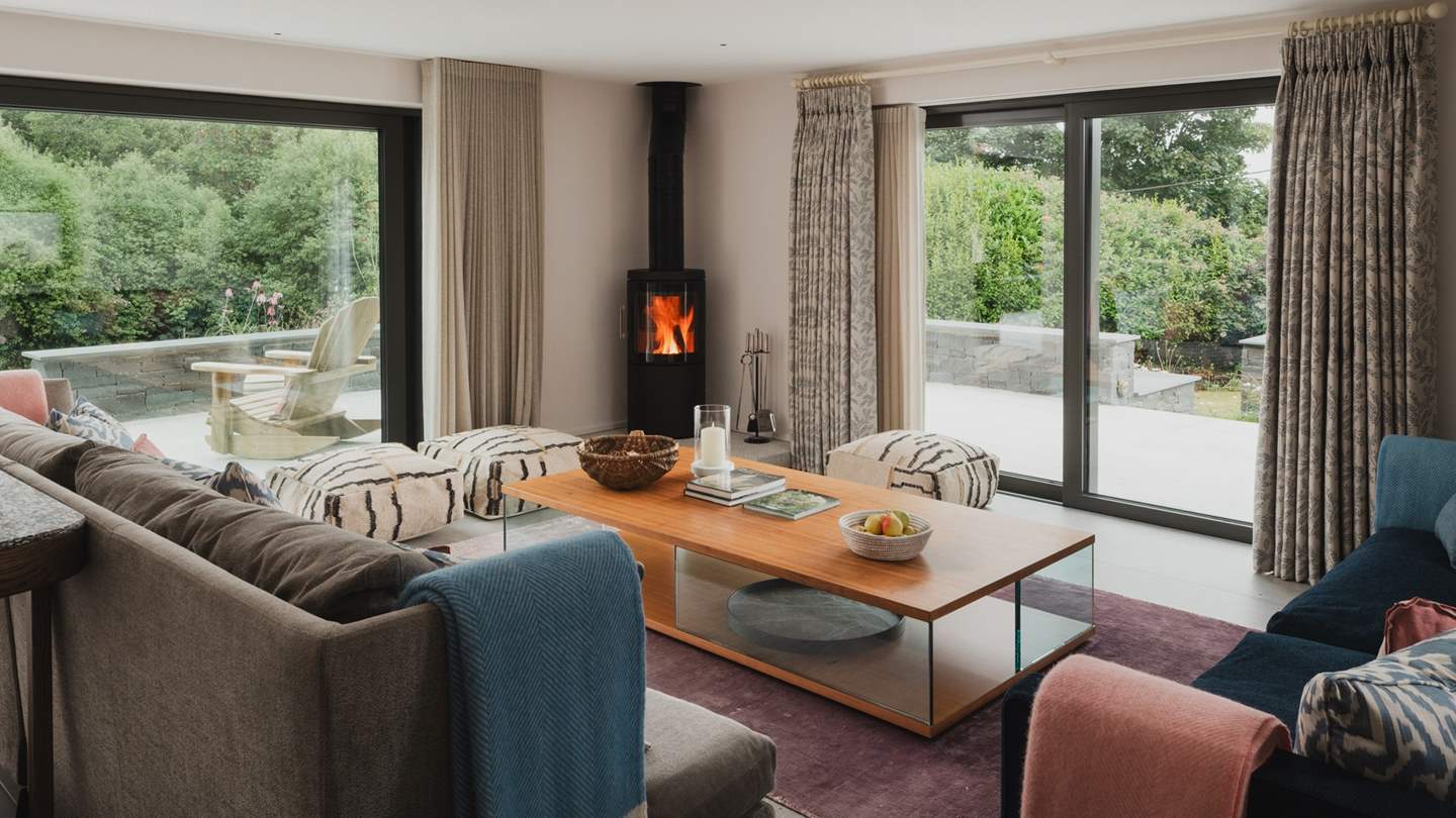 Seek cosy staycation moments beside the wood burning stove in the open plan living room... 
