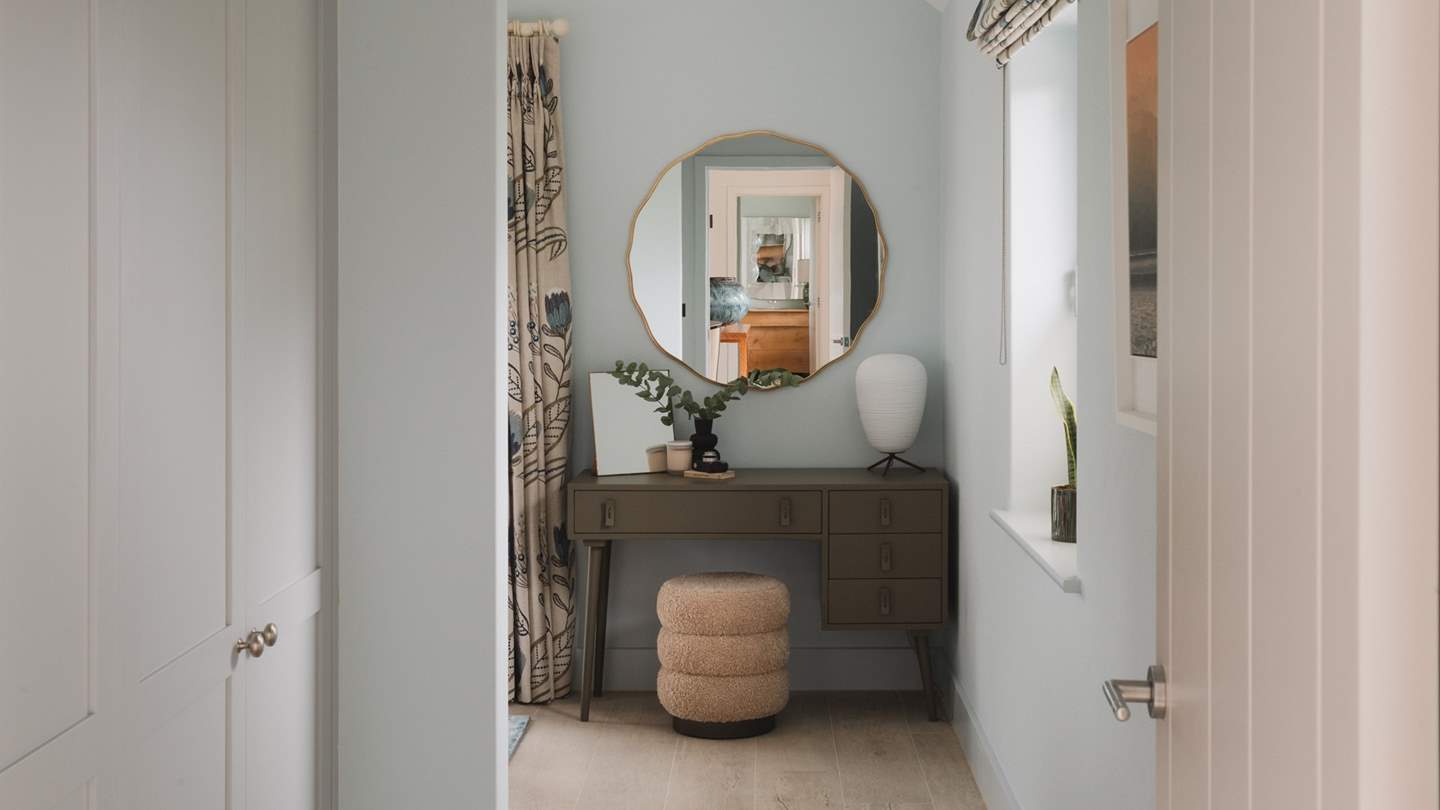 You'll find a dressing table and stool in this gorgeous space