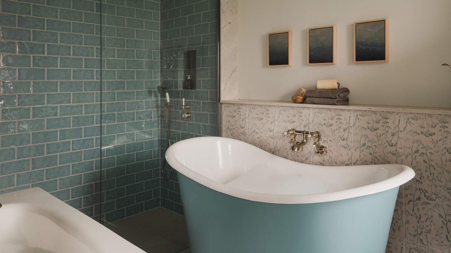 Continuing the calming colour palette is the en suite bathroom, where you’ll find an Albion rolltop freestanding bathtub