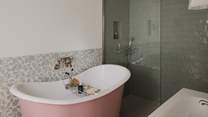 Spellbinding soaks await in the rose-pink rolltop Albion bathtub