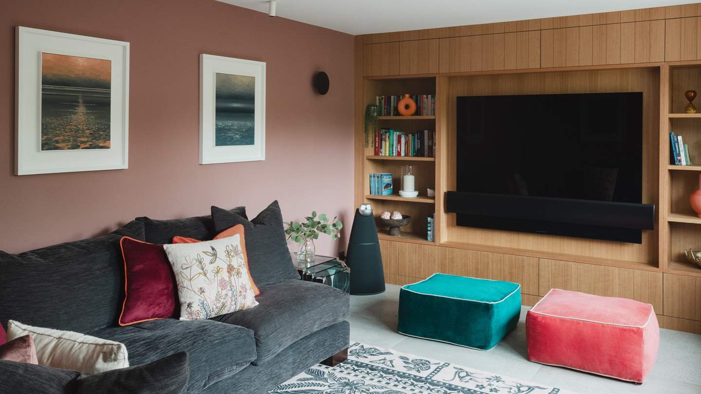 For entertainment, discover Bang and Olufsen sound system and a Bang and Olufsen Sky TV, set within a bespoke wood-panelled media wall