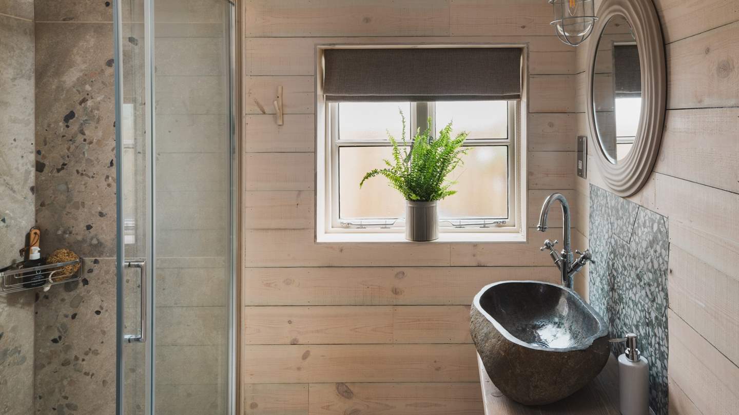 Relish refreshing showers in the inviting shower, with terrazzo tiling 