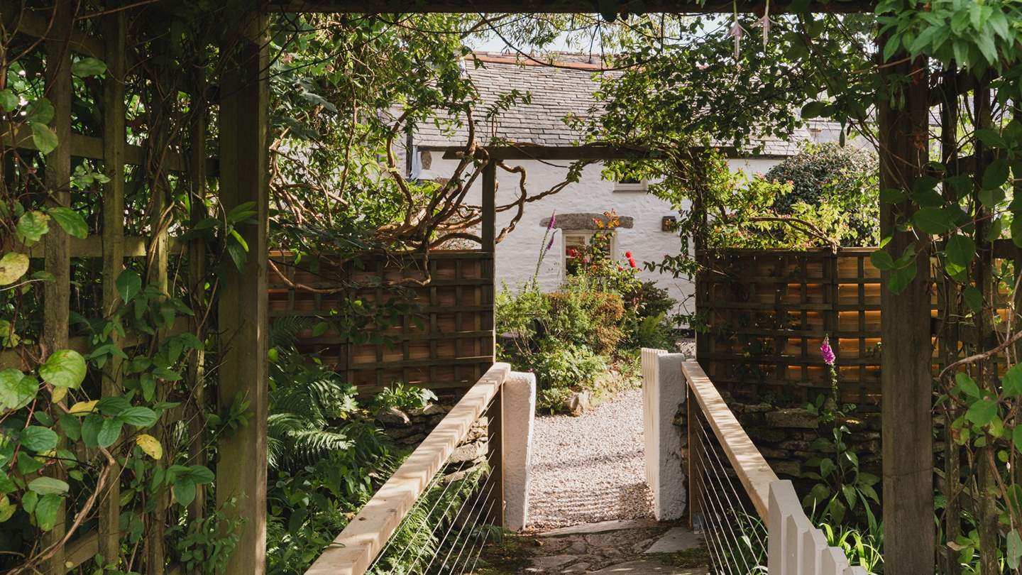 Cross a small bridge into the cottage garden 