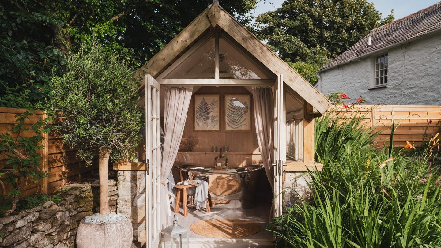 A unique addition to this dreamy retreat, uncover the luxurious outdoor bath house