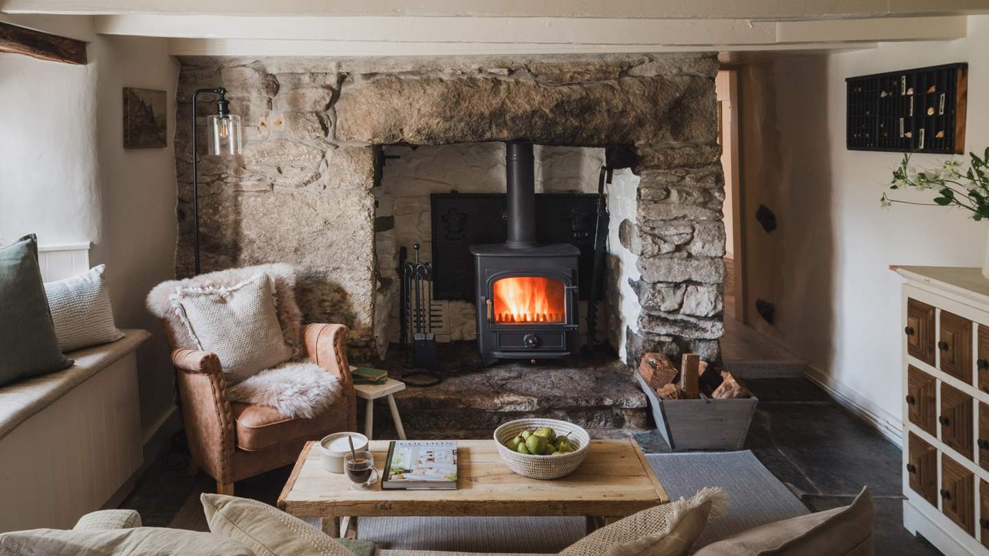 Uncover an inviting living space in soothing neutral tones, complete with a heart-warming wood burning stove 