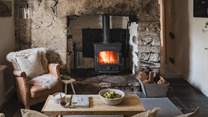 Relax beside the fire from the sheepskin armchair, watching your favourite series on the Smart TV